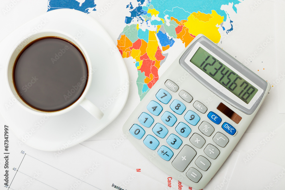 Coffee cup over world map - view from top