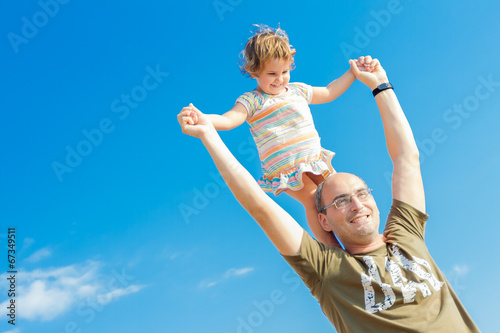 happy father and baby child girl playing outdoors