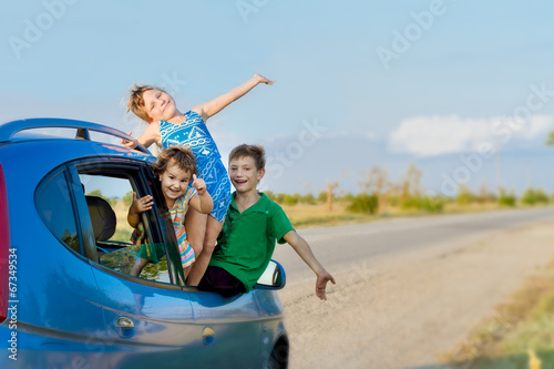 three happy kids in car, family trip, summer vacation travel © Alena Yakusheva