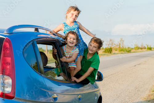 three happy kids in car, family trip, summer vacation travel © Alena Yakusheva