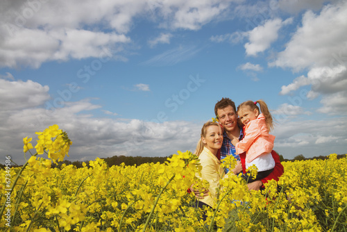 happy family outdoor in rape field