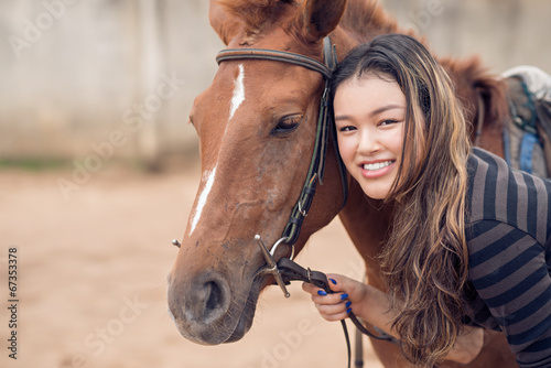Chestnut pony and girl