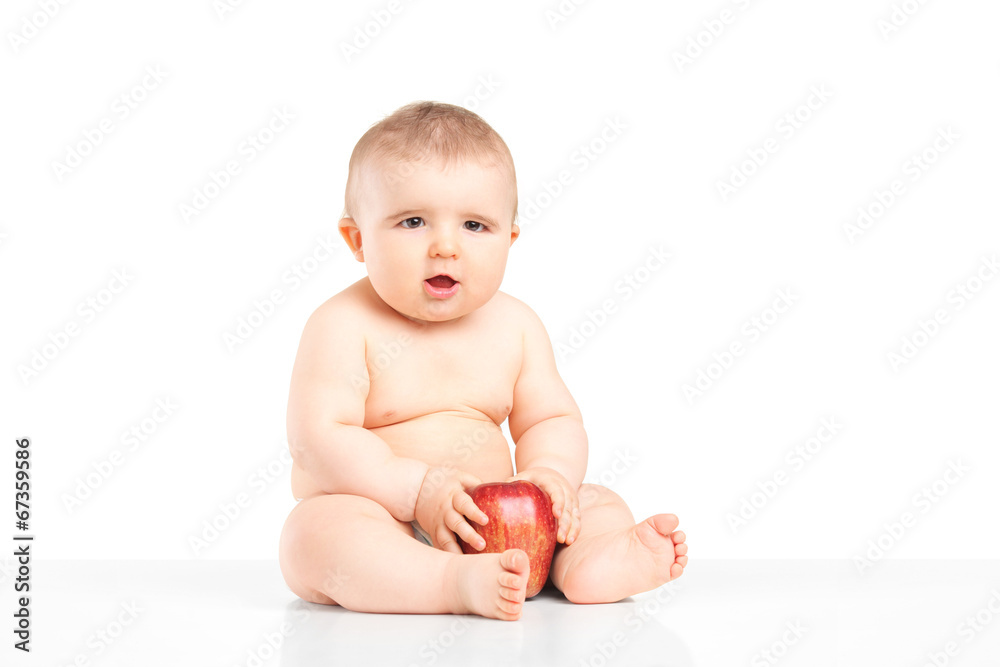 Baby boy playing with a red apple Baby boy playing with a red apple