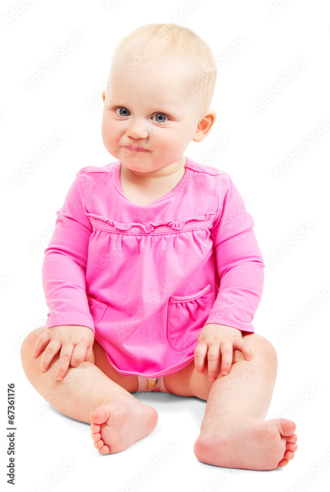 The beautiful smiling little girl in dress sits The beautiful smiling little girl in dress sits