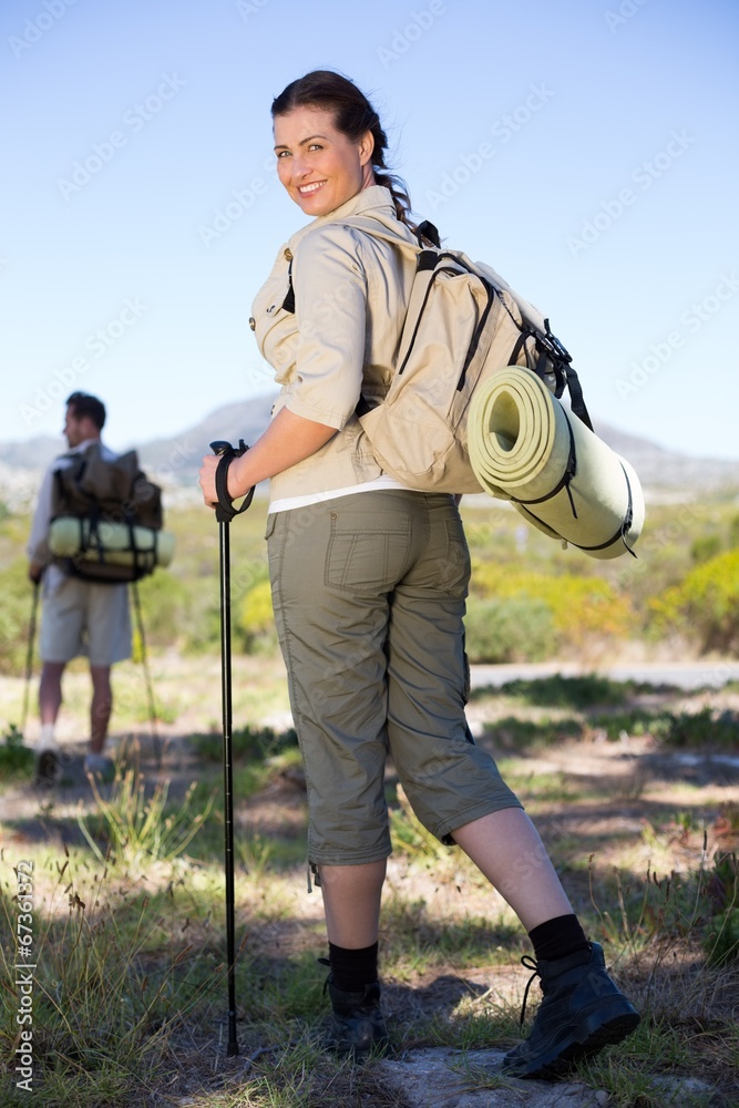 Happy hiking couple walking on mountain trail Happy hiking couple walking on mountain trail