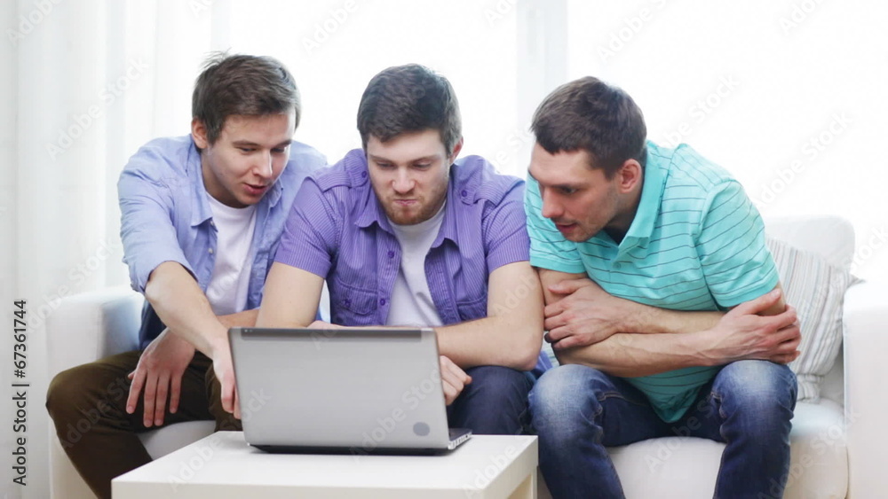 smiling friends with laptop computer at home smiling friends with laptop computer at home
