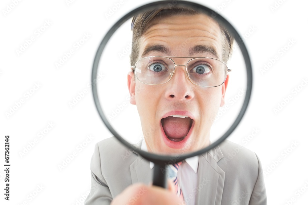 Geeky businessman looking through magnifying glass Geeky businessman looking through magnifying glass