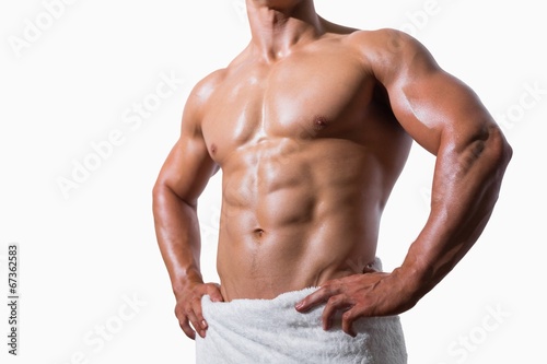 Mid section of a shirtless muscular man in white towel