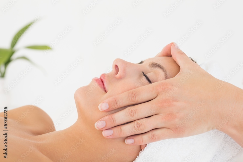 Attractive woman receiving facial massage at spa center Attractive woman receiving facial massage at spa center