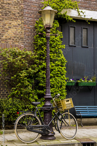 Bicycle tied on a light pole in Amsterdam