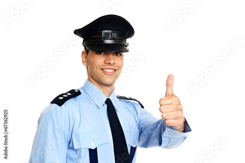 Smiling young policeman in uniform shows you thumb up