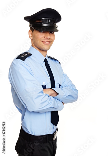 Obraz na plátně Portrait of young smiling policeman standing