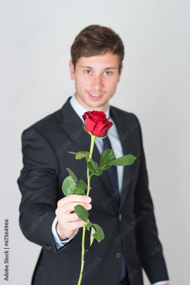 handsome young man in suit with a rose handsome young man in suit with a rose