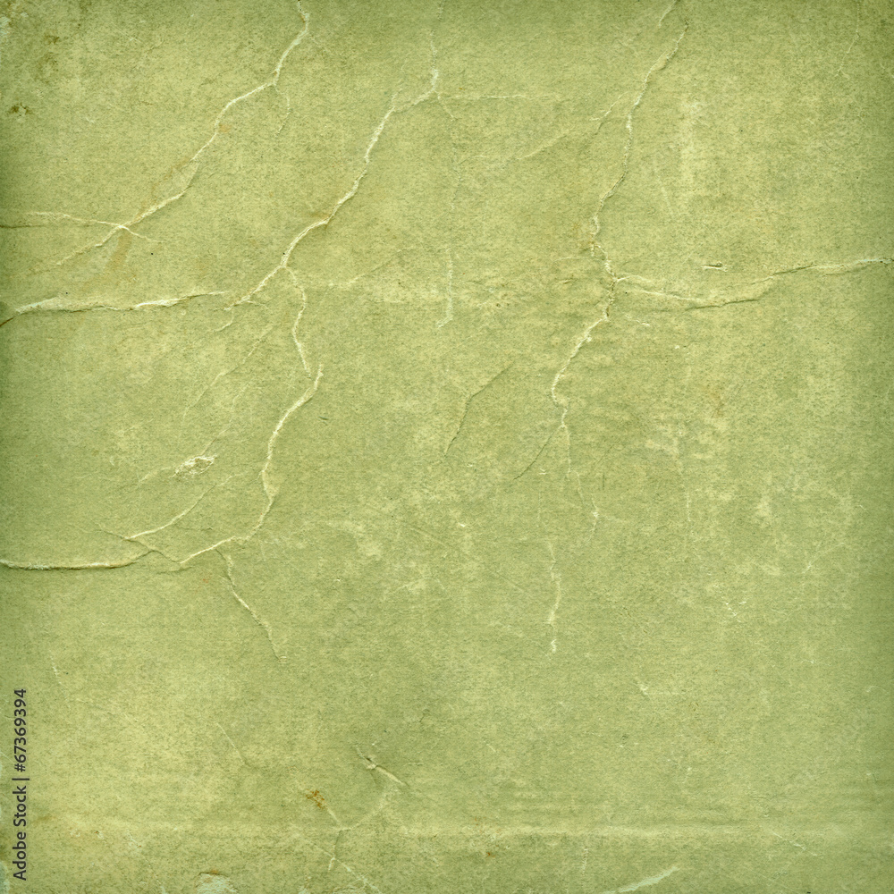 Fototapeta premium Green paper texture with aged creases features a weathered olive sage surface, offering a vintage distressed backdrop for scrapbooking, artistic layouts, and graphic design