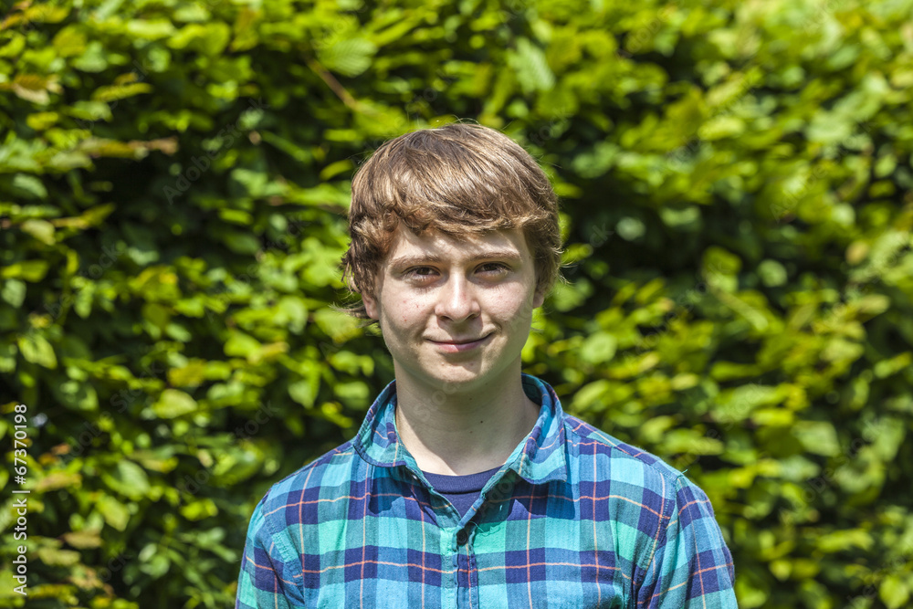 attractive happy smiling boy in the garden attractive happy smiling boy in the garden