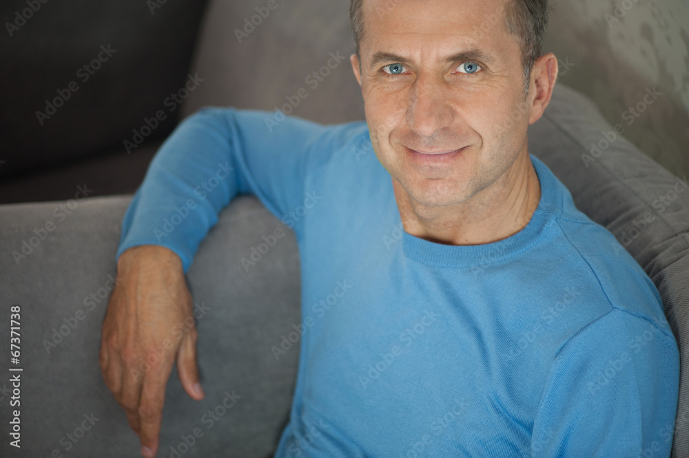 Serene happy man relaxing on sofa at home Serene happy man relaxing on sofa at home