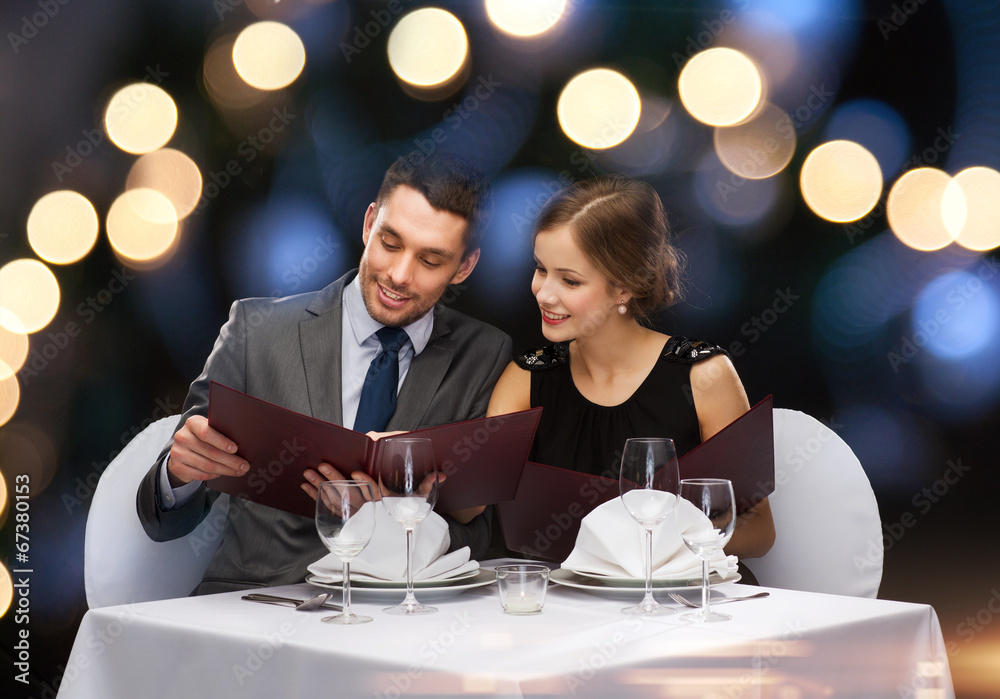 smiling couple with menus at restaurant smiling couple with menus at restaurant