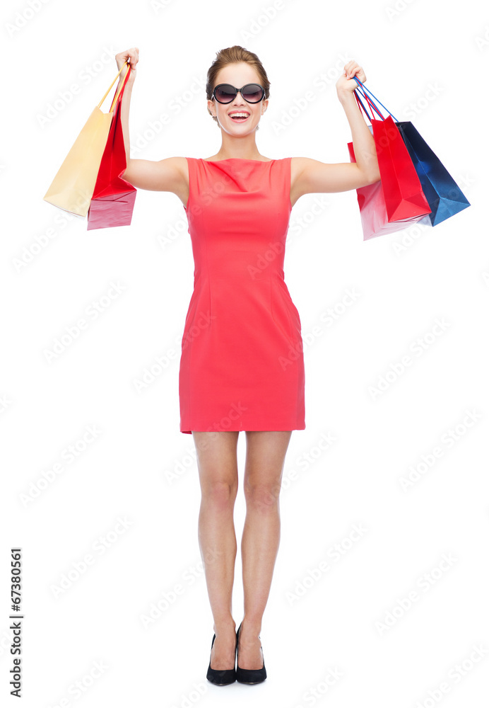 smiling woman in red dress with shopping bags smiling woman in red dress with shopping bags