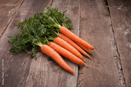 fresh carrot bunch on grungy wooden background