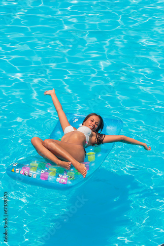 A girl is relaxing in a swimming pool