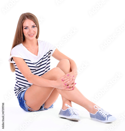 Beautiful young girl in shorts and t-shirt isolated on white