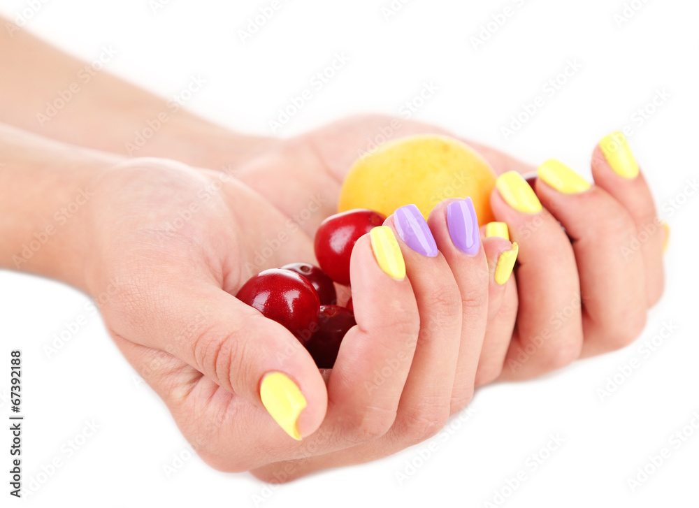 Female hands with stylish colorful nails holding ripe berries