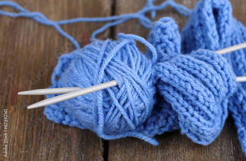 Yarns for knitting on wooden table close-up