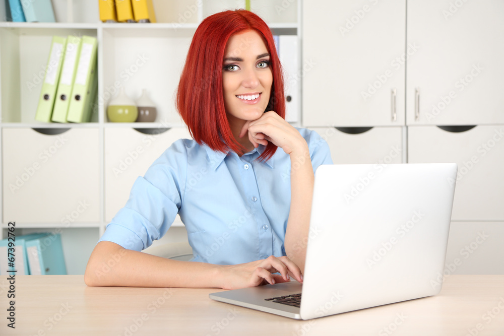 Young beautiful business woman with laptop in cabinet Young beautiful business woman with laptop in cabinet