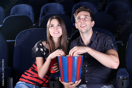 Young couple watching movie...