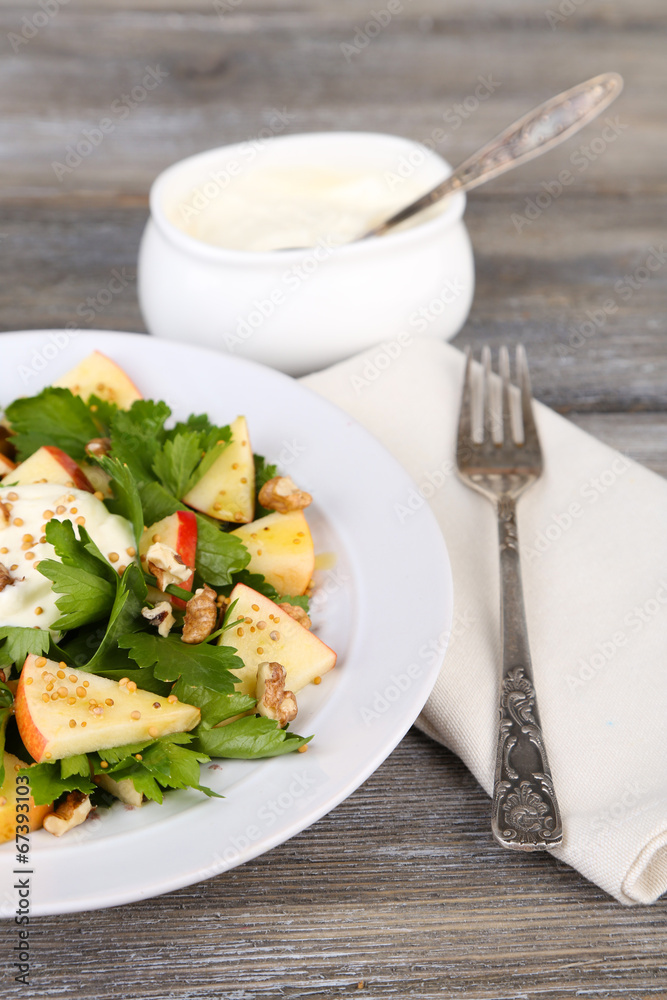 Green salad with apples, walnuts and cheese on wooden Green salad with apples, walnuts and cheese on wooden