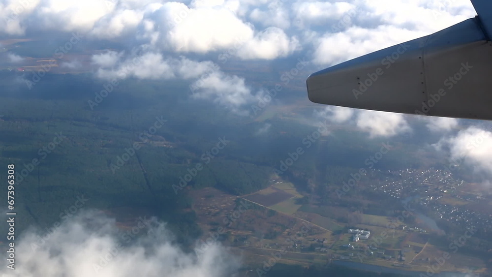 View of earth and clouds from banking aircraft View of earth and clouds from banking aircraft