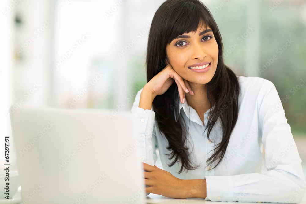 young indian businesswoman sitting in office young indian businesswoman sitting in office