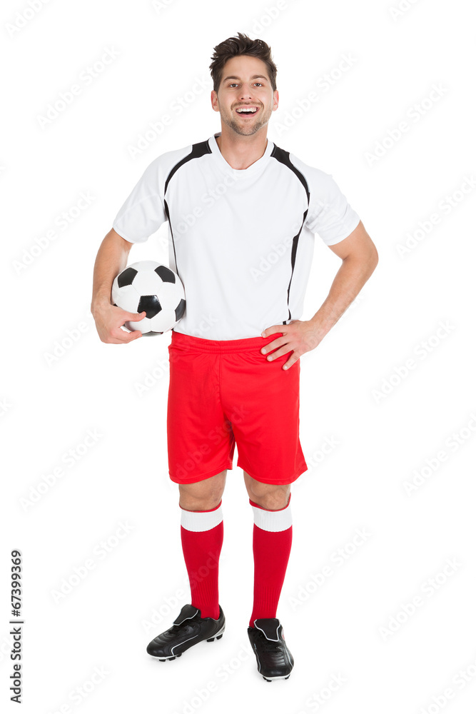 Soccer Player Holding Football