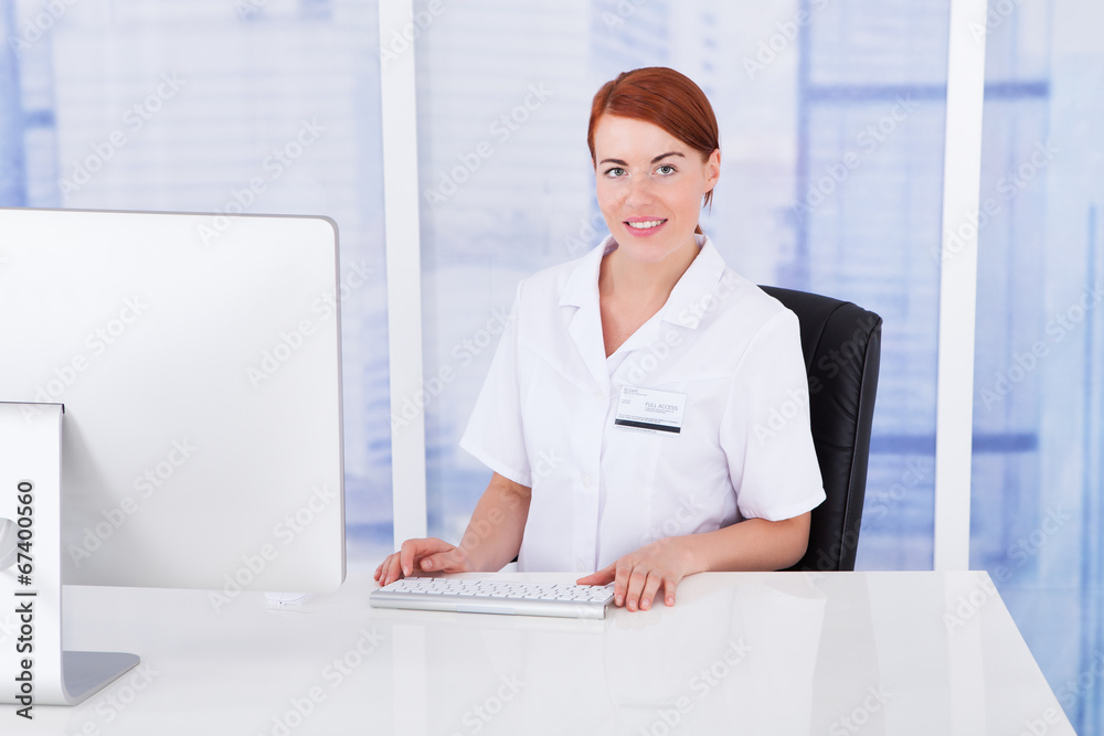 Confident Female Doctor Using Computer Confident Female Doctor Using Computer