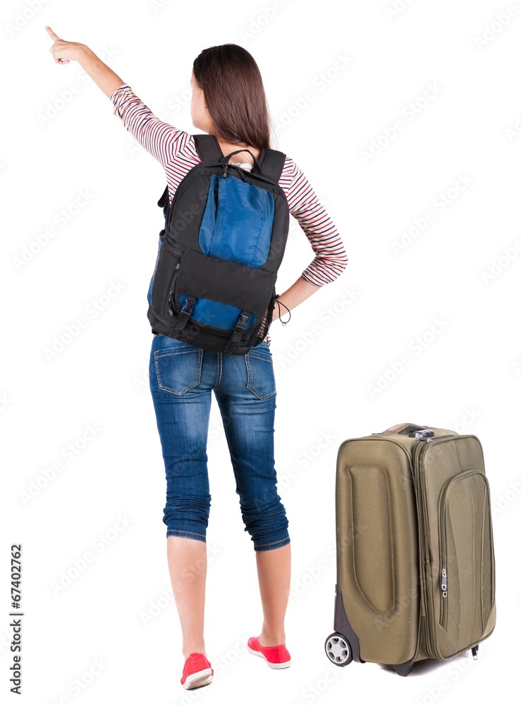 Back view of pointing woman with backpack looking up. Back view of pointing woman with backpack looking up.