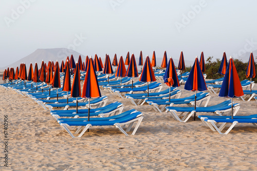 Sun loungers on beach © Paul Maguire