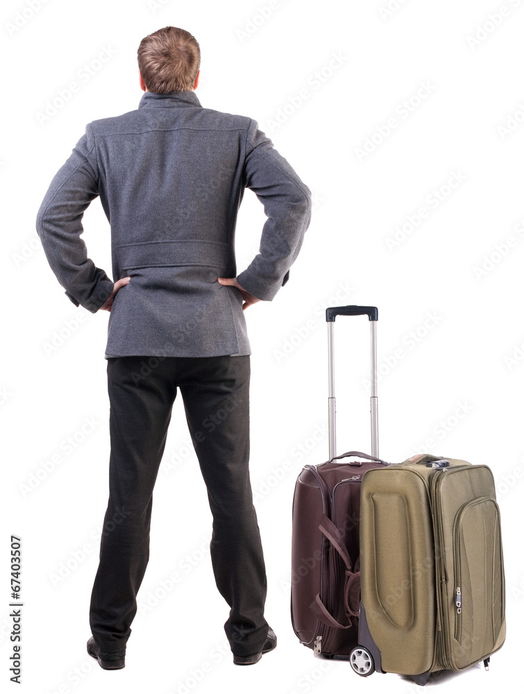 Back view of young man traveling with suitcas. Back view of young man traveling with suitcas.