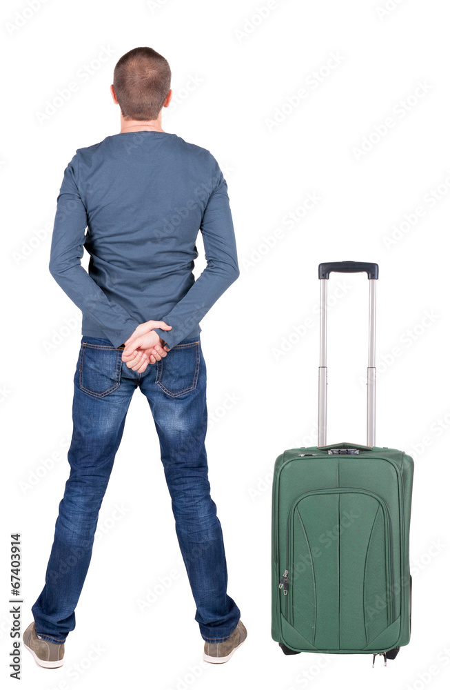 Back view of young man traveling with suitcas. Back view of young man traveling with suitcas.