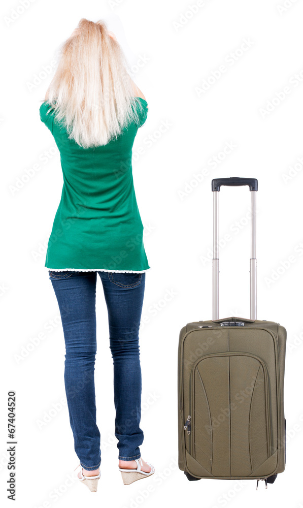 back view of standing young beautiful  blonde woman.