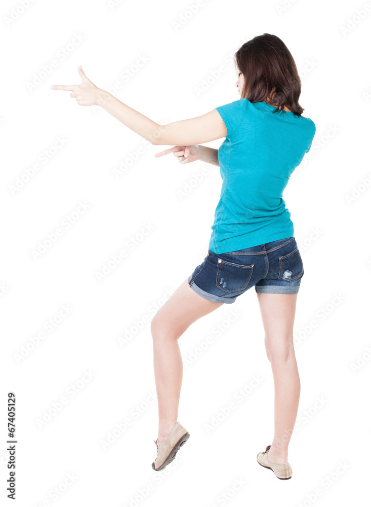 Back view of pointing woman. beautiful brunette girl in shorts Back view of pointing woman. beautiful brunette girl in shorts