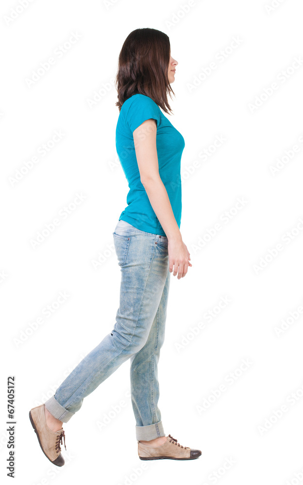 back view of walking woman in jeans . back view of walking woman in jeans .