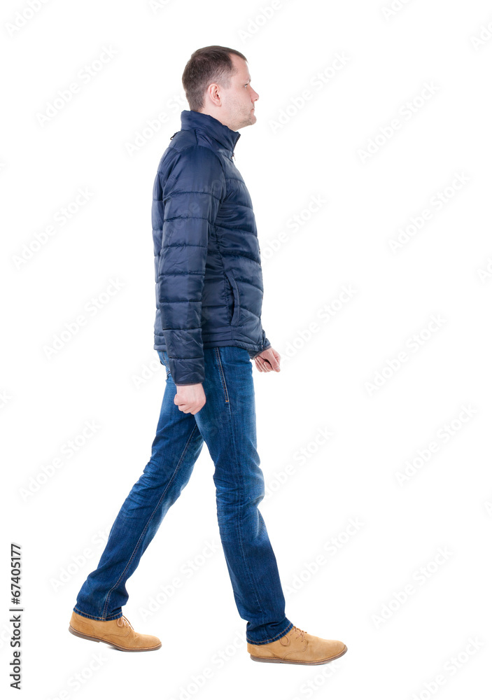 Back view of going handsome man in jeans and jacket. Back view of going handsome man in jeans and jacket.