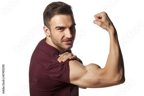 Canvas Print young handsome guy shows his strong arm