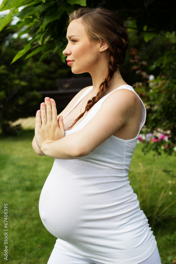 Beautiful pregnant woman relaxing in the park Beautiful pregnant woman relaxing in the park
