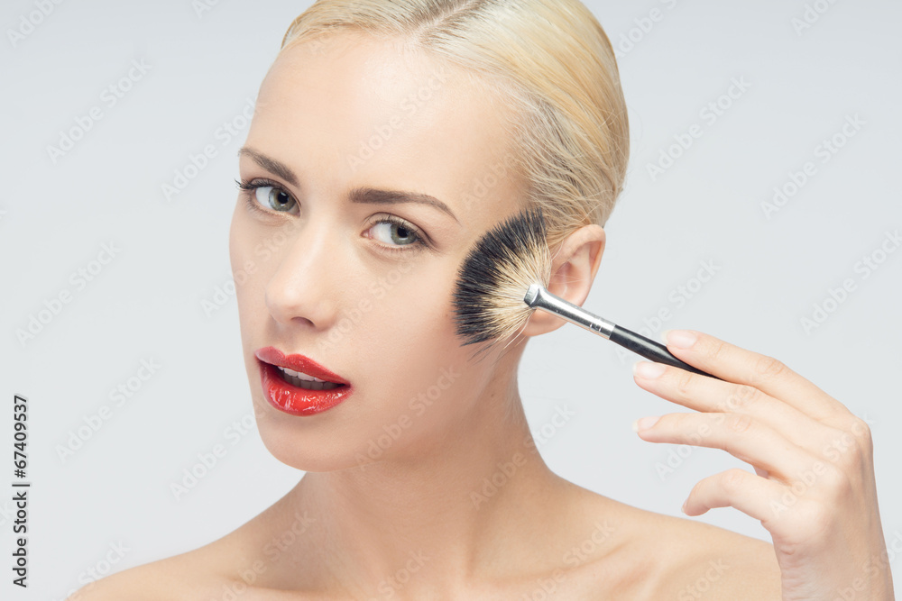 Beautiful Young Woman Applying Makeup with Brush Beautiful Young Woman Applying Makeup with Brush