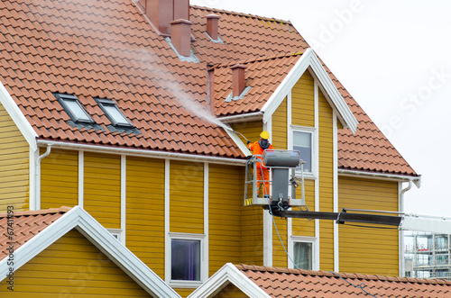 Worker In Platform Washing Building