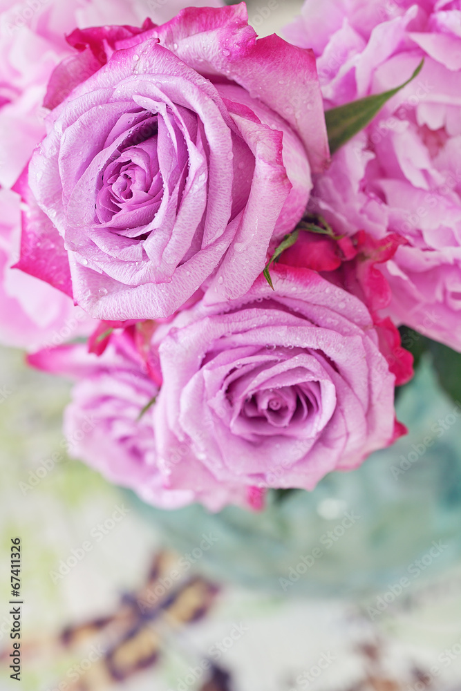 Floral composition with a pink peony and roses in a glass vase. Floral composition with a pink peony and roses in a glass vase.
