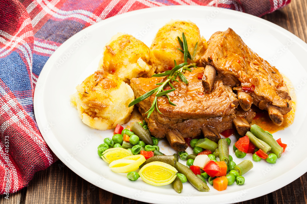 Pork spareribs served with mashed potatoes Pork spareribs served with mashed potatoes
