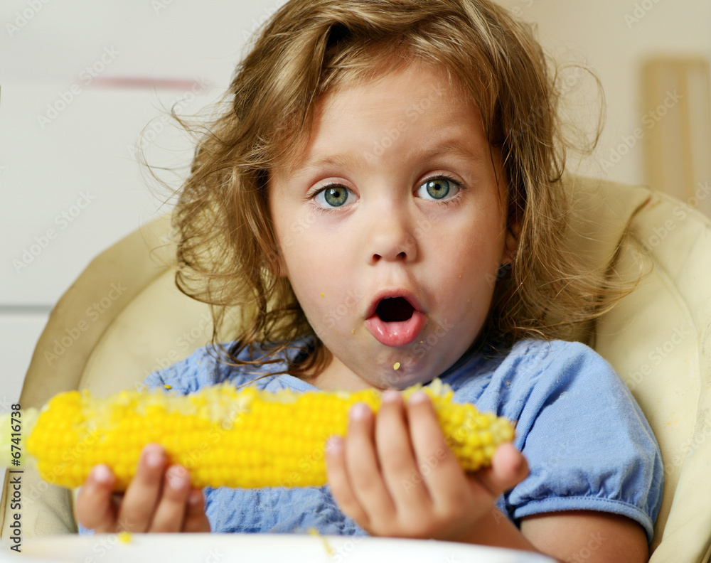 toddler eating corn