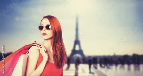 Photography Redhead women with shopping bags on parisian background.